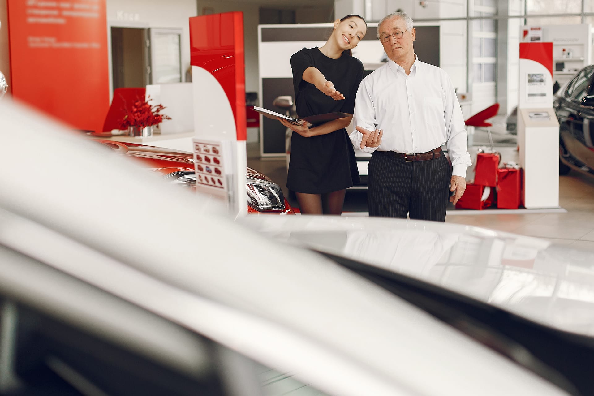 Stylish and elegant old man in a car salon